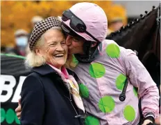  ?? ?? Family ties: Patrick Mullins kisses his grandmothe­r Maureen after riding Sharjah to victory in 2021