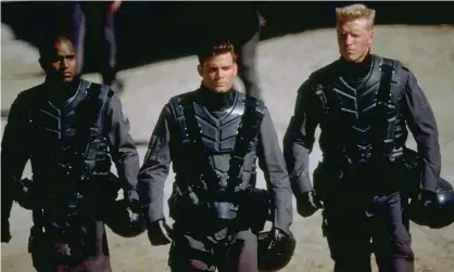  ?? Photograph: Allstar/Touchstone Pictures ?? Cheerful militarism … Seth Gilliam, Casper Van Dien and Jake Busey in Starship Troopers.