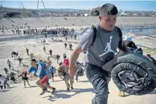  ??  ?? FRANTIC: Migrants run from Mexican police at the Chaparral border crossing in Tijuana, Mexico.