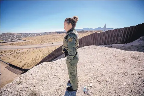  ?? ROBERTO E. ROSALES/JOURNAL ?? Border Patrol Agent Veronica Martinez stands near the border wall that runs along the Sunland Park area.