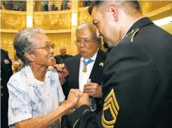  ?? NEW MEXICAN FILE PHOTO ?? Terry Miyamura, wife of Medal of Honor recipient Hiroshi ‘Hershey’ Miyamura, center, is introduced to Medal of Honor recipient Leroy Petry at the state Capitol Rotunda in 2011.