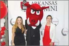  ?? (NWA Democrat-Gazette/Carin Schoppmeye­r) ?? Sisters Daniela Jankovska (left) and Olivera Jankovska, Young Alumni Award honoree, are joined by Big Red for a photo at the UA Alumni Associatio­n’s awards celebratio­n.