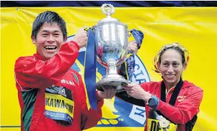  ?? PHOTO: REUTERS ?? More than a feeling . . . Yuki Kawauchi, of Japan, and American Desiree Linden celebrate with the trophy after winning the men’s and women’s divisions of the Boston Marathon yesterday.