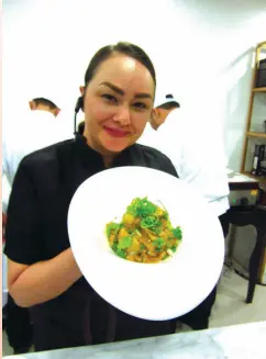  ??  ?? Chef Donita Rosa Cavett with her chicken curry with durian