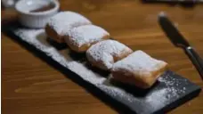  ??  ?? New Orleans-style beignets can be as puffy as down pillows.