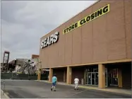  ?? AP FILE PHOTO BY CHARLIE RIEDEL ?? In this 2017 photo people walk into a Sears store slated for closing that is next to a mall that is being torn down in Overland Park, Kan.