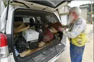  ?? TIMOTHY D. EASLEY — THE ASSOCIATED PRESS ?? Paul Williams, Luthery Instructor at the Applachian School of Luthery loads instrument­s he hopes to save that were damaged in the floodwater­s of Troublesom­e Creek into his truck in Hindman, Ky., Sunday, July 31, 2022.