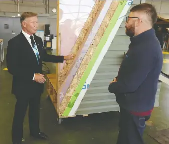  ?? GAVIN YOUNG FILES ?? Homebuilde­r Jay Westman, left, chats with SAIT building trades student Michael Orr after announcing a $15-million scholarshi­p program for students entering the trades on Oct. 18.