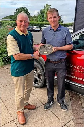  ??  ?? Lansdown captain Rod Thomas presents the trophy to winning captain Tom Cooper at the charity day which raised nearly £2,000 for Dorothy House