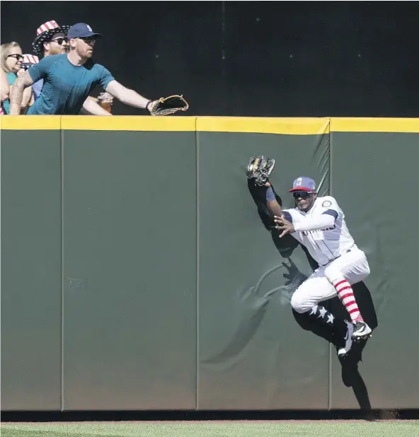  ?? — GETTY IMAGES ?? Centre-fielder Guillermo Heredia of the Seattle Mariners hits the wall after making a catch on a ball off the bat of Alex Gordon of the Kansas City Royals during the second inning at Safeco Field on Tuesday. The Royals won 7-3.