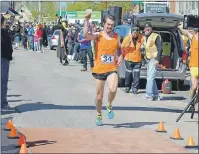  ?? NANCY KING/CAPE BRETON POST ?? Eric McCarthy crosses the finish line in Baddeck during the 2016 Cabot Trail Relay, helping the Maine-iacs capture their sixth relay victory.