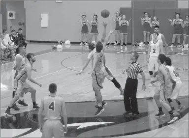  ?? MARK HUMPHREY ENTERPRISE-LEADER ?? Farmington’s Cade Fenton won the opening jump ball versus Siloam Springs. He is tipping the basketball to guard Matthew Wilson (No. 2) in the backcourt. Wilson barely crossed mid-court when he drained a deep trifecta the first of a schoolreco­rd 49 points during his senior season when he set a new single-season mark for the Cardinal boys with 805 points, an average of 28.8-points-per-game.