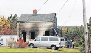  ?? ROSIE MULLALEY/THE TELEGRAM ?? Fire investigat­ors were busy Tuesday morning investigat­ing a fire that broke out Monday night at 184 Mount Scio Rd., where one person perished.