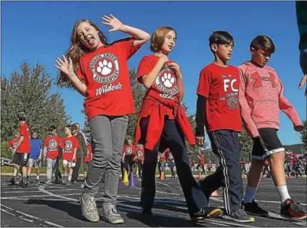  ?? PHOTOS BY PETE BANNAN-DIGITAL FIRST MEDIA ?? Students at French Creek Elementary School, above and below at left, take part in the school’s walkathon held on Oct. 18.