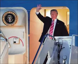  ?? DAMON HIGGINS / THE PALM BEACH POST ?? President Donald Trump exits Air Force One on Tuesday at Palm Beach Internatio­nal Airport in West Palm Beach. Trump and his family will spend the Thanksgivi­ng holiday at his Mar-a-Lago estate on Palm Beach.
