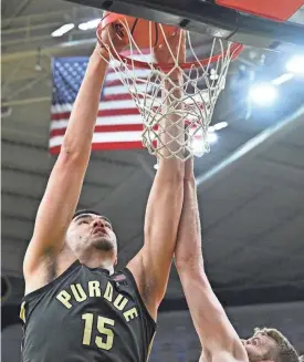  ?? JEFFREY BECKER/USA TODAY SPORTS ?? Purdue center Zach Edey dunks over Iowa forward Ben Krikke on Saturday at Carver-Hawkeye Arena.