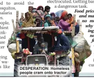  ?? ?? DESPERATIO­N: Homeless people cram onto tractor