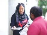  ?? MELISSA GOLDEN/THE NEW YORK TIMES ?? Nicole Fauster, an intern with Project South, hands out informatio­n about civil rights amid concerns over immigratio­n raids at the Patel Plaza, home to many South Asian businesses, in Decatur, Ga., on Saturday.