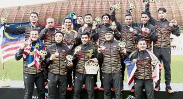  ??  ?? We deserve this: The Malaysian rugby team celebratin­g after beating Singapore in the Rugby 7s final yesterday.