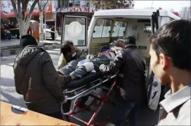  ?? AP PHOTO/ RAHMAT GUL ?? People help carry an injured man to the hospital following a suicide attack in Kabul, Afghanista­n, Saturday Jan. 27, 2018. The Public Health Ministry says dozens were killed and over 100 wounded in a suicide car bombing in downtown Kabul.