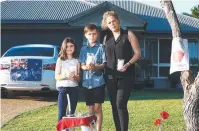  ??  ?? DOING THEIR BIT: Nicole Dalla Vecchia on her Kanimbla driveway with her children, Sienna, 10, and Blake, 12.