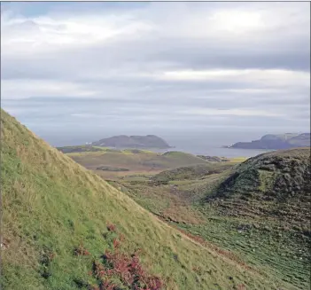  ?? 25_c34courier­walk16 ?? Climbing out of the ‘U’ shaped valley with Davaar island and Ailsa Craig just visible in the haze.