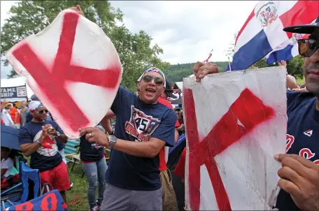  ?? PHOTO BY MATT STONE ?? (Cooperstow­n, NY, 07/26/15) Pedro Martinez fans holding the strikeout K gather before the Hall of Fame induction at Clark Sports Center on Sunday, July 26, 2015. Staff