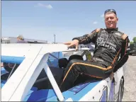  ?? Darron Cummings / Associated Press ?? Andy Bishop climbs out of his car following a practice session at Gas City I-69 Speedway on Sunday in Gas City, Ind. On a day usually reserved for IndyCar’s crown jewel race, Gas City I-69 Speedway an hour’s north of Indianapol­is had a handful of cars on a short dirt track.