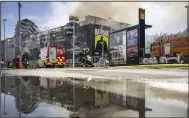  ?? (AP/Ritzau Scanpix/Mads Claus Rasmussen) ?? Firefighte­rs work on a fire that broke out at the Stock Exchange in Copenhagen, on Tuesday.