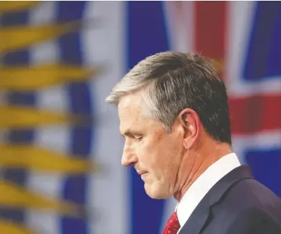  ?? DARRYL DYCK/ THE CANADIAN PRESS ?? Liberal Leader Andrew Wilkinson pauses while reading a statement at provincial election night headquarte­rs in Vancouver on Saturday. Wilkinson's use of “immediatel­y” in stepping down as leader has rattled some Liberals.