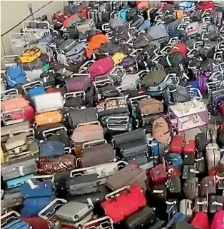  ?? AP ?? A sea of luggage at London’s Heathrow Airport amid the widespread disruption at UK airports during the northern hemisphere summer.