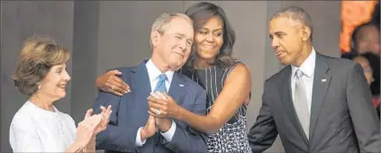  ?? JIM LO SCALZO/EPA ?? Laura and George W. Bush, from left, celebrate the opening of the National Museum of African American History and Culture on Saturday with Michelle and Barack Obama.