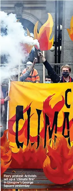  ?? ?? Fiery protest: Activists set up a ‘climate fire’ in Glasgow’s George Square yesterday