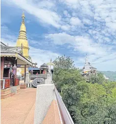  ?? ?? Wat Phra Phutthabat Pha Nam houses gold and white pagodas. Worshipper­s can climb to the top for a breathtaki­ng vista of lush greenery.