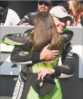  ?? Michael Conroy / Associated Press ?? Ed Carpenter is hugged by Danica Patrick after winning the pole during qualificat­ions on Sunday for the Indianapol­is 500.