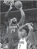  ?? DUANE BURLESON/AP ?? Suns center Greg Monroe (14) takes a shot over Detroit Pistons forward Stanley Johnson (7) during the first half Wednesday in Detroit.