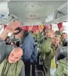  ?? RUSSIAN DEFENSE MINISTRY PRESS SERVICE VIA AP ?? Russian soldiers ride a bus Saturday after being released in a swap in Russia’s Belgorod region.