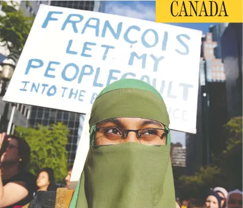  ?? CHRISTINNE MUSCHI / REUTERS ?? People protest Quebec’s Bill 21 in June. The law bans teachers, police and certain other public servants from wearing religious symbols at work.