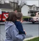  ?? COURTESY OF NATHAN DANIELS ?? A little boy waves as the Easter bunny makes the rounds Saturday in Exeter Township. The firsttime bunny tour was a collaborat­ion of township police officers and firefighte­rs.