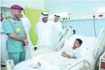  ?? Courtesy General Secretaria­t of the Executive Council ?? Saeed Eid Al Ghafli, Chairman of the Executive Office, and other Government officials visit students who were injured in the bus collision.