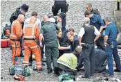  ??  ?? Tory MP Tobias Ellwood, centre, tries to save the life of PC Keith Palmer after the officer was stabbed by terrorist Khalid Masood