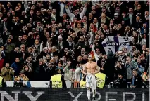  ??  ?? Ever the showman, Cristiano Ronaldo takes his shirt off in front of fans after converting the matchwinni­ng penalty.