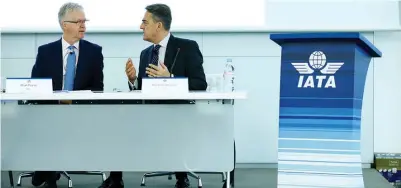  ?? (Pierre Albouy/Reuters) ?? IATA DIRECTOR-GENERAL and CEO Alexandre de Juniac (right) speaks with IATA chief economist Brian Pearce during a press conference in Geneva, Switzerlan­d, yesterday.