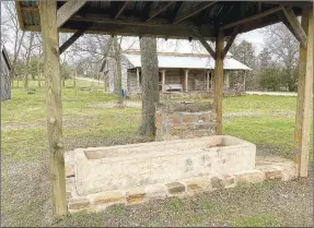  ??  ?? The watering trough and native stone well for the Morrow Homestead are protected under a covered roof.