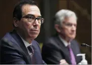  ?? TONI L. SANDYS — THE WASHINGTON POST VIA AP ?? Federal Reserve Chair Jerome Powell, right, and Treasury Secretary Steve Mnuchin testify during the Senate’s Committee on Banking, Housing, and Urban Affairs hearing examining the quarterly CARES Act report to Congress on Capitol Hill in September.