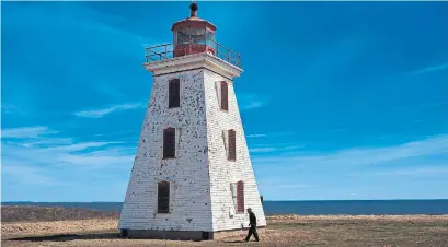  ?? ZANE WOODFORD PHOTOS STAR HALIFAX ?? Alcide Arsenault, 88, stands near the Cape Egmont lighthouse that his grandfathe­r once operated. The Cape Egmont lighthouse has already been moved away from the shoreline once, due to erosion.