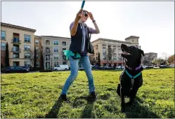  ?? RANDY VAZQUEZ – STAFF ARCHIVES ?? Verena Niemeier, left, plays with her dog Milos, right, at River Oak Park near Crescent Village in San Jose on Jan. 30. The apartment complex is the largest built in the U.S. in the last decade.