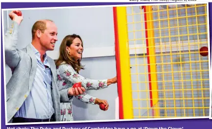  ??  ?? Hot shots: The Duke and Duchess of Cambridge have a go at ‘Down the Clown’ ...