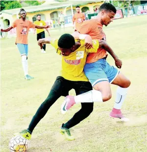  ?? RUDOLPH BROWN ?? Barbican’s Malik Douglas (left) and Adrian Williams of Dunbeholde­n FC in a tussle for the ball during a Magnum/ Charley’s JB Jamaica Football Federation Premier League play-off game at the Barbican Complex last year.