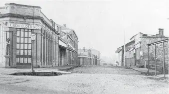  ?? IMAGE A-00726 COURTESY OF THE ROYAL B.C. MUSEUM AND ARCHIVES ?? Looking south on Wharf Street from Yates Street, 1860. James Yates’s second Ship Inn Saloon is the stone building on the right in the photograph.